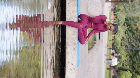 Young Serene African American Woman in Sportswear Resting After Workout in Summer Park