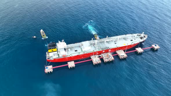 Tugs help the gas tanker to go to sea aerial view 4 K Turkey Alanya