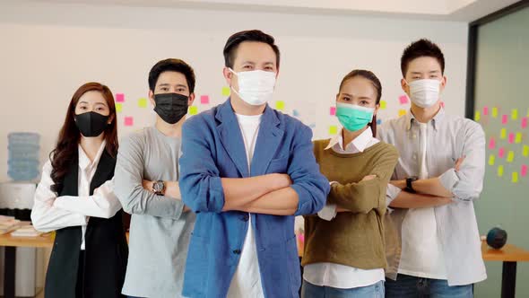 Group of Asian business men leader standing wearing mask smile cross arm confidence