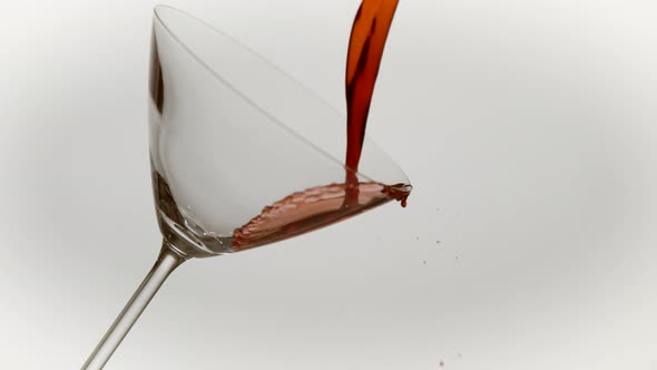 Pouring red wine into glass, Ultra Slow Motion