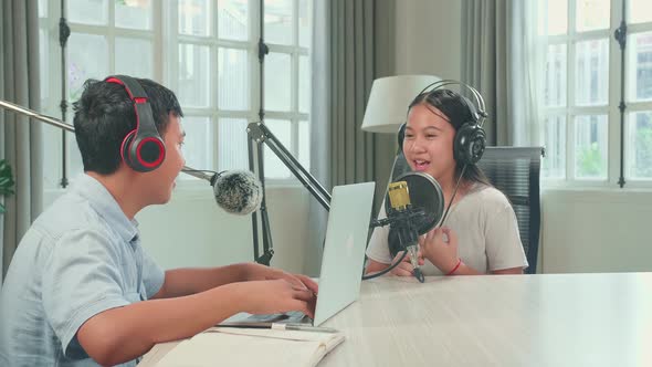 Asian Boy Host Record Podcast Use Microphone Wear Headphone With Laptop Interview Guest Conversation