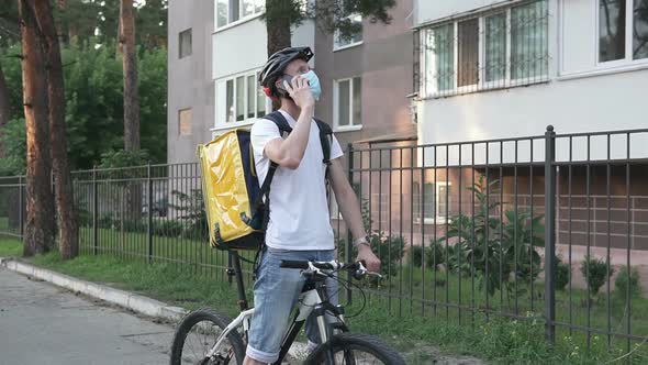 A phone call from a food delivery service on a bicycle in a yellow thermo backpack