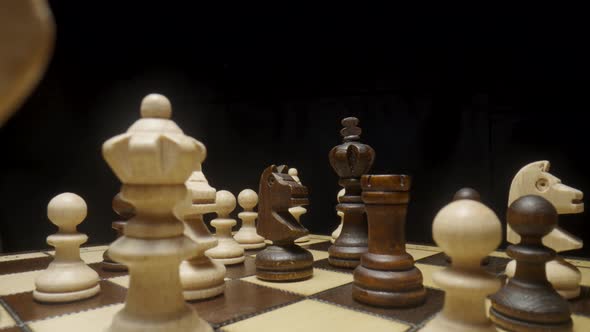 Camera Pans Over Chessboard with Chess Pieces Placed and Focuses on Brown Horse