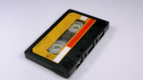 Audio Cassette Rotates on White Background