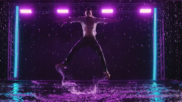 Emotional Performance of Contemporary Ballet Choreography in the Rain in Dark Studio with Purple