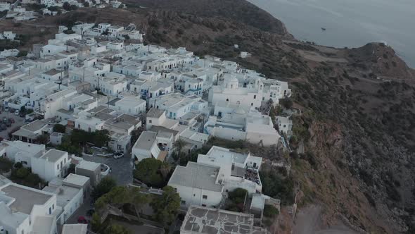 Aerial View Over Typically Greek Village Small Town on Island in Sunset Golden Hour Light