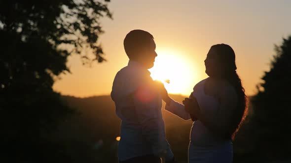 Silhouette of a Young Couple Dancing at Sunset