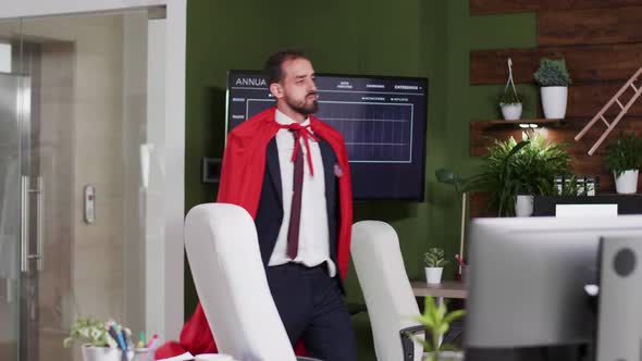 Slow Motion Shot of Businessman Wearing a Red Cape Walking Silly in the Office