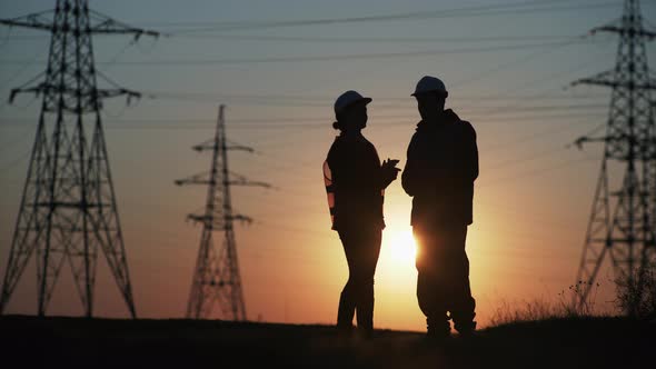 Construction Manager Architect and Consultant Engineer Man in Protective Helmets Discuss Project 