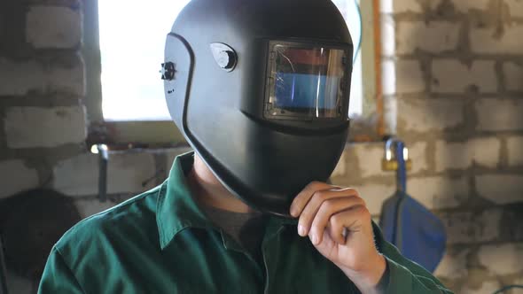 Welder Opens Mask and Looking at Camera