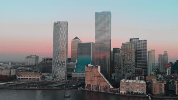 Rising Drone aerial shot of London Canary Wharf at sunset