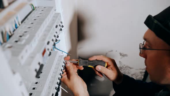 The Master Electrician Strips the Insulation From the Cable for Connection to the Circuit Breakers