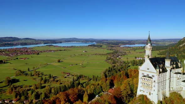 Neuschwanstein castle with autumn color tree background, Aerial close up