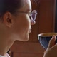 Adult woman in glasses sipping hot coffee - VideoHive Item for Sale