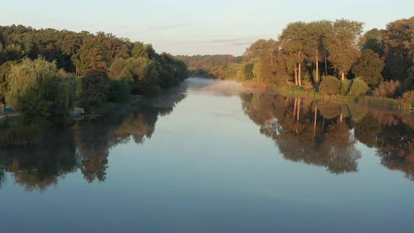 Beautiful morning, summer flight over the river. Fog, trees.