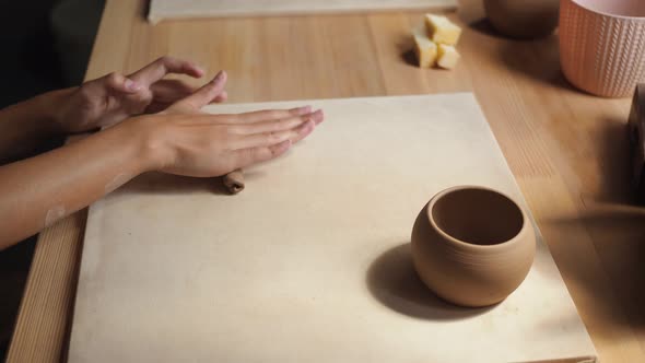 Front View of Female Potter Kneading Softly Clay on Worktop with Her Hands