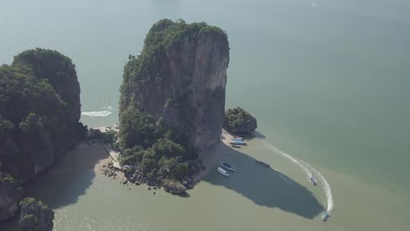 Aerial view of James Bond island, limestone cliffs in sea, sailing boats. Phuket, Krabi, Thailand