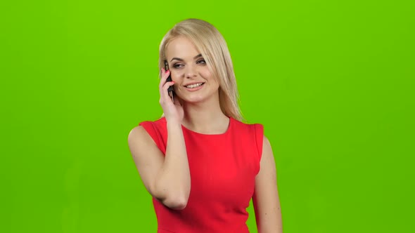 Girl with Smile Talking on Mobile Phone on Green Screen