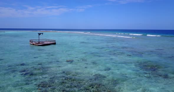 Beautiful aerial clean view of a white paradise beach and blue water background in 4K