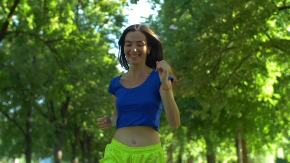 Female Runner Jogging During Outdoor Workout in Park