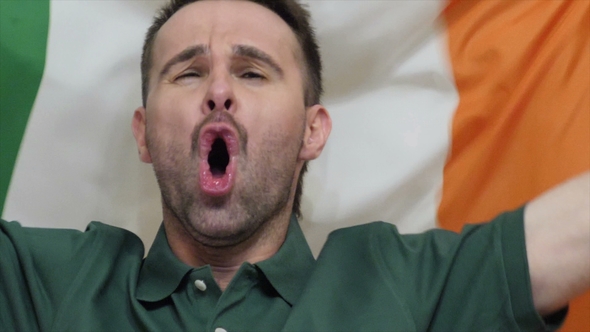 Irish Fan Celebrates Holding the Flag of Ireland