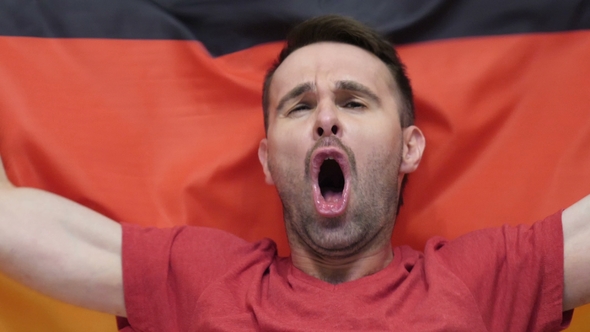 German Fan Celebrates Holding the Flag of Germany