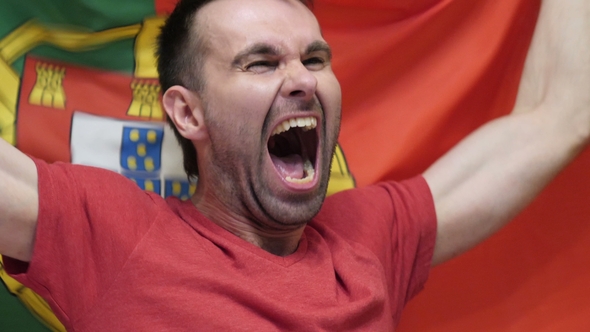 Portuguese Fan Celebrating While Holding the Flag of Portugal