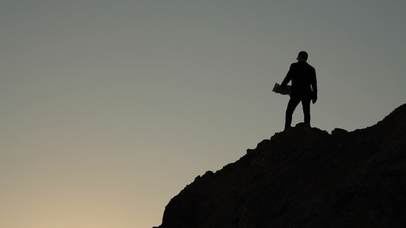 Man Throws Documents From a Cliff