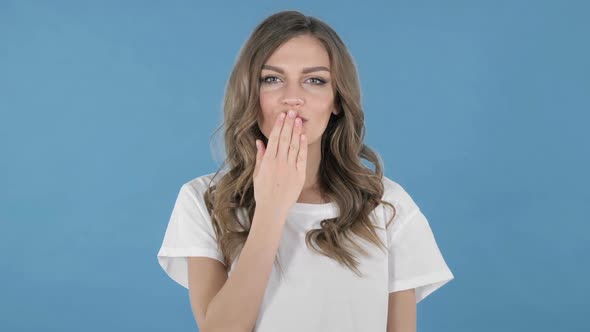 Flying Kiss By Young Girl Isolated on Blue Background