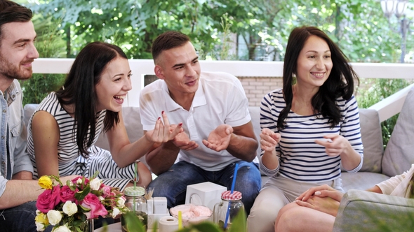 Group of Friends Making Bet Shaking Hands at Meeting in Coffeehouse