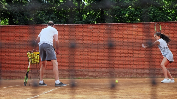 Coacher Teaching Young Girl To Playing Tennis