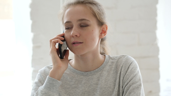 Young Woman Talking on Phone in Loft Workplace