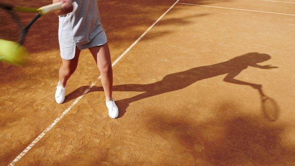 Legs of Tennis Player on Orange Clay Tennis Court During the Game