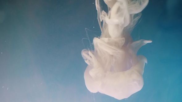 Colorful Rainbow Paint Drops From the Bottom Mixing in Water alt