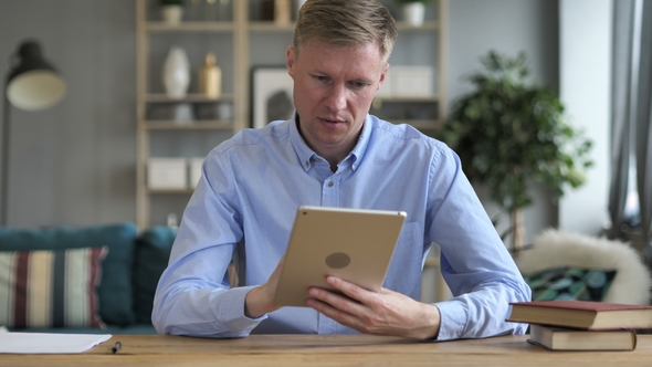 Businessman Using Tablet at Workplace