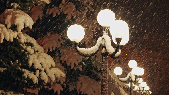 Beautiful Strong Snowfall in the Light of a Street Lamps