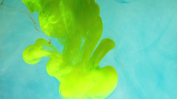 Colorful Rainbow Paint Drops From the Bottom Mixing in Water. . alt