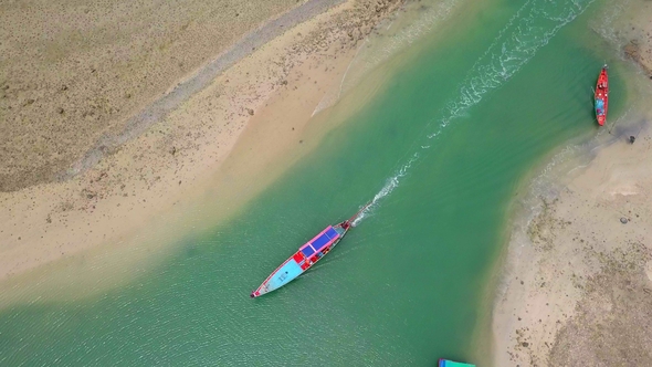 Aerial View of Thai Traditional Longtail Boat Sailing Through Waterway Channel Made in Sand Beach
