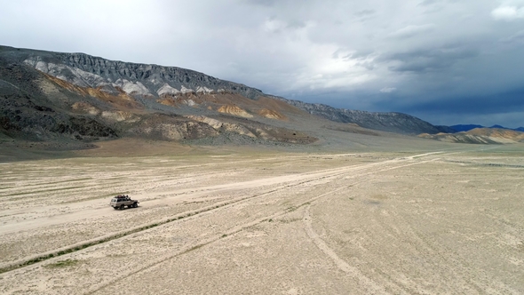 Aerial View of Safari Vehicle Driving on Sand Track Road in the Altay Mountain