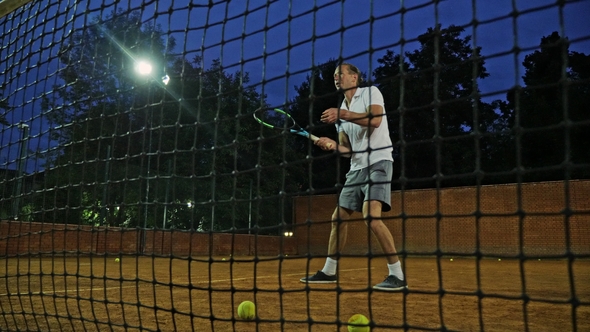  Young Attractive Man Playing Tennis on Orange Clay Tennis Court