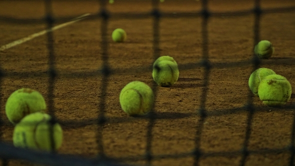 Tennis Balls Lie on the Tennis Court