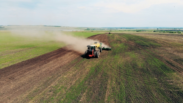 Tractor Is Riding Across a Massive Field Scattering It with Seeds