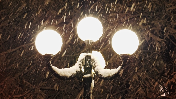 Beautiful Strong Snowfall in the Light of a Street Lamp