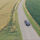 Aerial View of Black Car Driving Through Fields - VideoHive Item for Sale