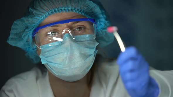 Scientist Holding Capsule in Forceps, Breast Cancer Chemotherapy Development