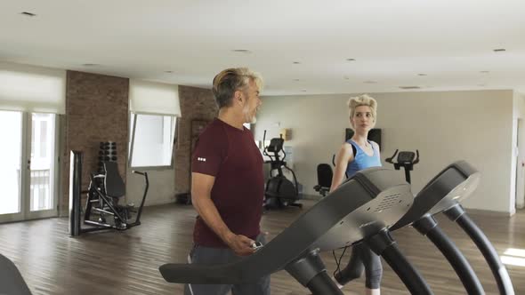 Man and woman exercising in gym