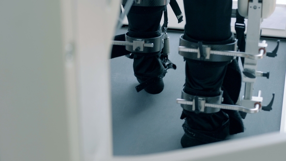 Back View of Fixated Male Feet Walking Along the Simulation Track