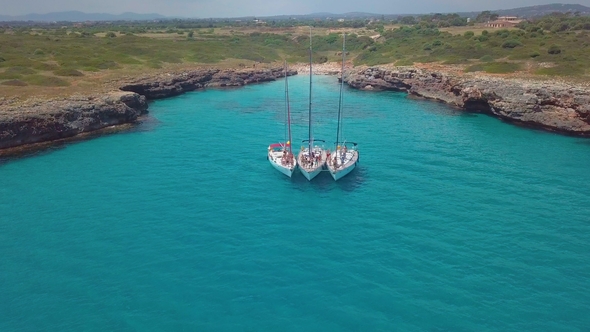 Top View of the Sailing Boats in Blue Lagoon. Swimmers Enjoying in Clear Blue Sea