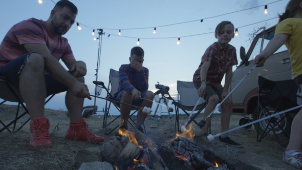 Laughing Family Frying Marshmellow on Bonfire