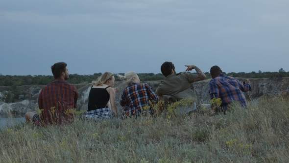 Friends Relaxing on Cliff and Having Fun